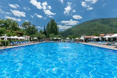 a pool at a resort with people swimming in it at Комплекс Варвара - Хотел и Минерални басейни in Varvara