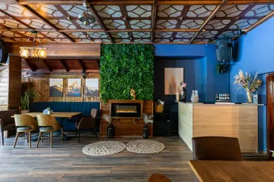 a restaurant with blue walls and a table and chairs at Комплекс Варвара - Хотел и Минерални басейни in Varvara
