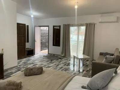 a living room with a bed and a couch at Комплекс Варвара - Хотел и Минерални басейни in Varvara