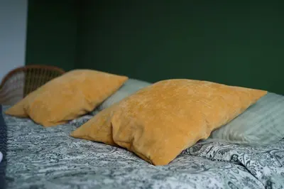 two pillows sitting on top of a bed at NDK Skyline Studio in Sofia
