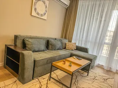 a living room with a couch and a coffee table at 1BR Apartment with a Free Designated Parking Space in Plovdiv