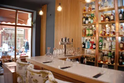 a bar in a restaurant with glasses on the counter at 1BR Apartment with a Free Designated Parking Space in Plovdiv