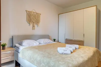 a bedroom with a bed with towels on it at Forest Harmony 1BD with Balcony & Parking by Flat Manаger in Smolyan