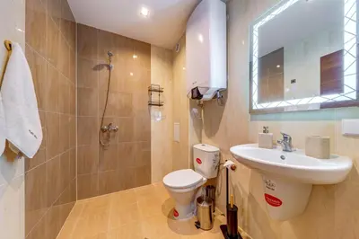 a bathroom with a toilet and a sink and a shower at Forest Harmony 1BD with Balcony & Parking by Flat Manаger in Smolyan