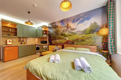 a bedroom with a large painting on the wall at Into the Woods - Charming Studio by Flat Manager in Smolyan