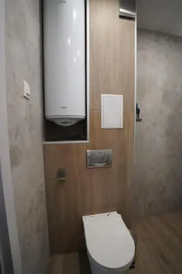 a bathroom with a white toilet and a cabinet at Coziness and comfort in the heart of tranquility in Sofia