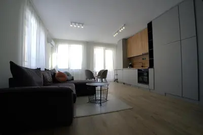 a living room with a couch and a table at Coziness and comfort in the heart of tranquility in Sofia
