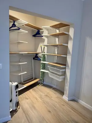 a walk in closet with wooden shelves and lights at Coziness and comfort in the heart of tranquility in Sofia