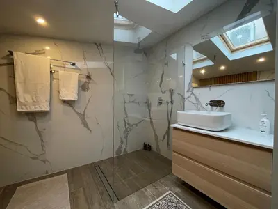 a bathroom with a sink and a shower with a counter at Boutique apartment with Mountain View in Sofia