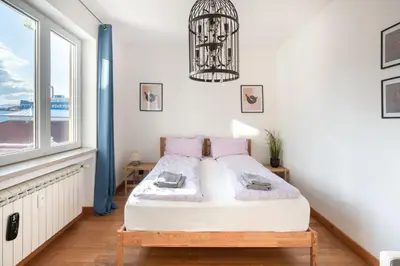 a bedroom with a bed and a window at Roca House in Sofia