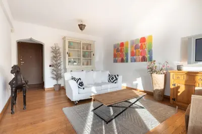 a living room with a white couch and a table at Roca House in Sofia
