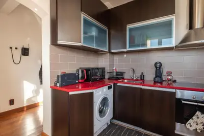 a kitchen with a washer and a washing machine at Roca House in Sofia