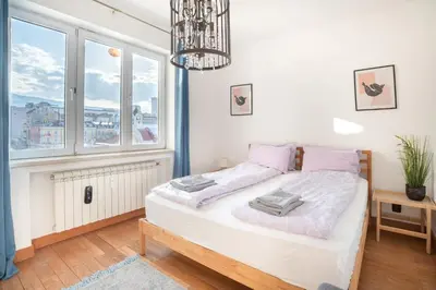 a bedroom with a bed and a large window at Roca House in Sofia