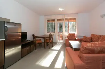 a living room with a couch and a table at Вилно селище Тракия- почивка сред природата in Tsigov Chark