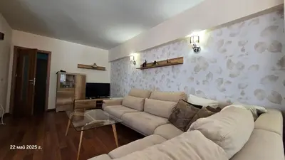 a living room with a couch and a wall with birds at Хотел Тото Шанс in Velingrad