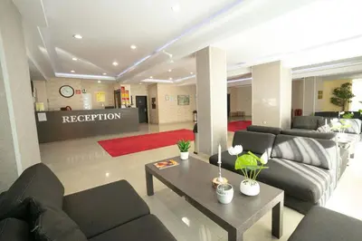 a living room with two couches and a coffee table at Хотел Тото Шанс in Velingrad