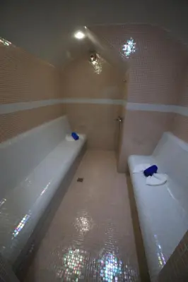 a bathroom with a tub and a toilet and a shower at Хотел Тото Шанс in Velingrad