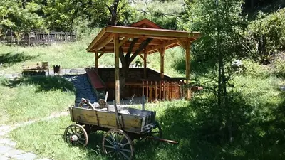 an old cart with a gazebo in a field at Villa Persenk in Lyaskovo