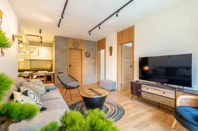 a living room with a couch and a tv at Arte Apartment in Sofia