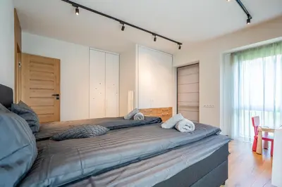 a bedroom with a large bed with towels on it at Arte Apartment in Sofia