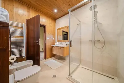 a bathroom with a shower and a toilet and a sink at Luxury Mountain Villa Pirin Golf K29H02 by Top Kvartiri Ltd in Razlog