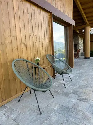 two green chairs sitting on a patio at Luxury Mountain Villa Pirin Golf K29H02 by Top Kvartiri Ltd in Razlog