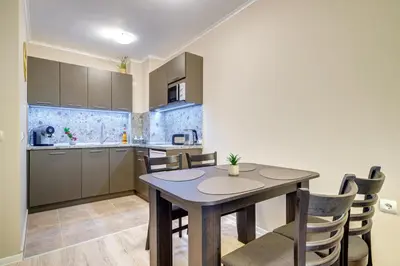 a kitchen and dining room with a table and chairs at Dream View 1BD - Quick Slope Access by Flat Manager in Pamporovo