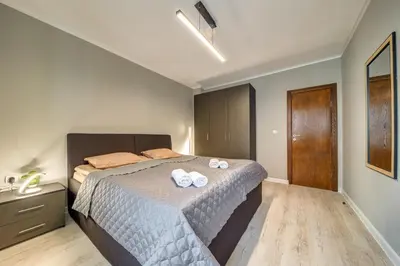 a bedroom with a bed with two towels on it at Dream View 1BD - Quick Slope Access by Flat Manager in Pamporovo