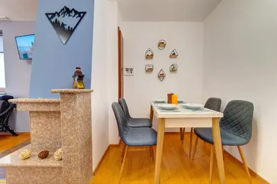 a dining room with a table and chairs at Colorful Retreat - 1BD next to the slopes by Flat Manager in Pamporovo