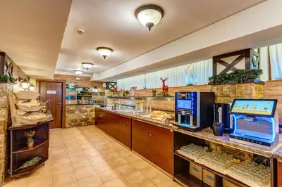 a large restaurant with a food counter with a food court at Colorful Retreat - 1BD next to the slopes by Flat Manager in Pamporovo