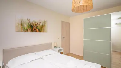 a bedroom with a bed and a painting on the wall at Cozy 1BD Apartment next to NDK by Flat Mаnager in Sofia