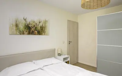 a bedroom with a bed and a painting on the wall at Cozy 1BD Apartment next to NDK by Flat Mаnager in Sofia