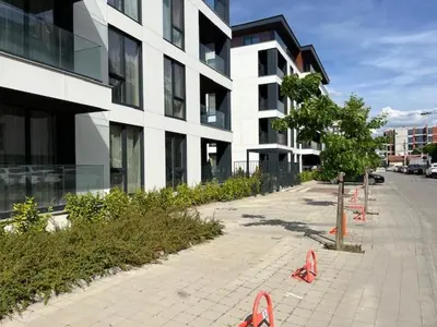 a sidewalk in front of a building with red objects at Gran Capital - Vodoley Rose Garden !Free Parking! in Sofia