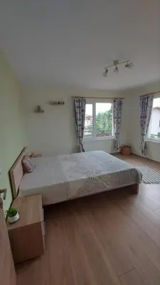 a bedroom with a large bed in a room at Бащината Къща in Sapareva Banya