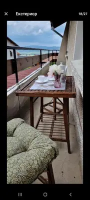 a table on a balcony with a view of the ocean at Бащината Къща in Sapareva Banya