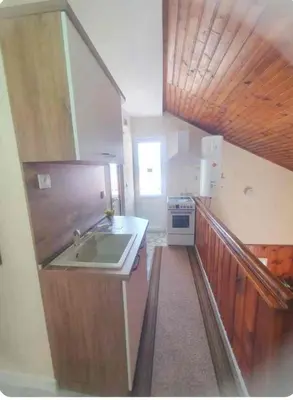 a small kitchen with a sink and a stove at Бащината Къща in Sapareva Banya