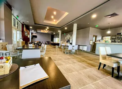 a restaurant with tables and chairs and a counter at Апартамент Елегант - спа комплекс Аква Терми in Krasnovo