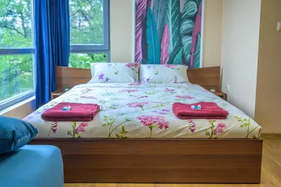 a bedroom with a bed with two towels on it at Comfy & Chic Apartment , SWU , FREE Parking in Blagoevgrad