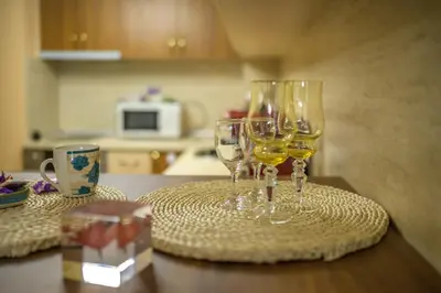 two glasses of wine sitting on a table at Comfy & Chic Apartment , SWU , FREE Parking in Blagoevgrad