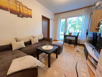 a living room with a couch and a table at Giza Cozy 1BDR w WiFi near Arena 8888 and SofiaMed in Sofia