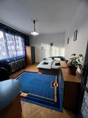 a living room with a blue rug on the floor at Sofia Harmony Apartment in Sofia