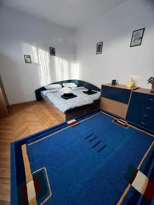a bedroom with a bed and a blue rug at Sofia Harmony Apartment in Sofia