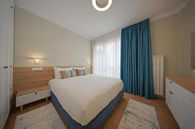 a bedroom with a large bed and a window at Miro's Central Apartment in Sofia