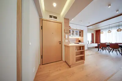 a living room with a door and a dining room at Miro's Central Apartment in Sofia