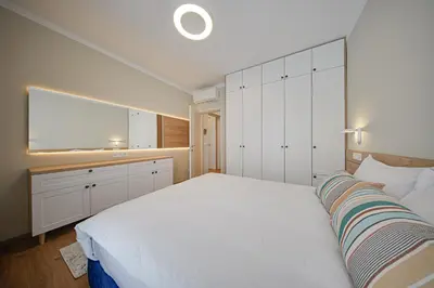 a bedroom with a large bed and a large window at Miro's Central Apartment in Sofia