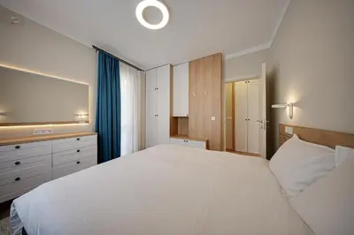 a bedroom with a large white bed and a television at Miro's Central Apartment in Sofia