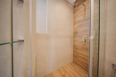 a shower with a glass door in a bathroom at Miro's Central Apartment in Sofia
