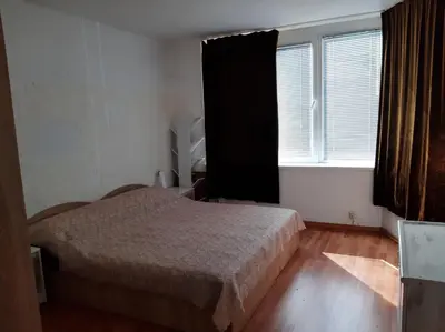 a small bedroom with a bed and a window at Дом Борисови in Sofia