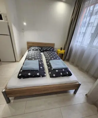 a bedroom with a bed with stars on it at Sunny Day in Sofia