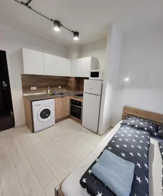 a small kitchen with a bed in a room at Sunny Day in Sofia